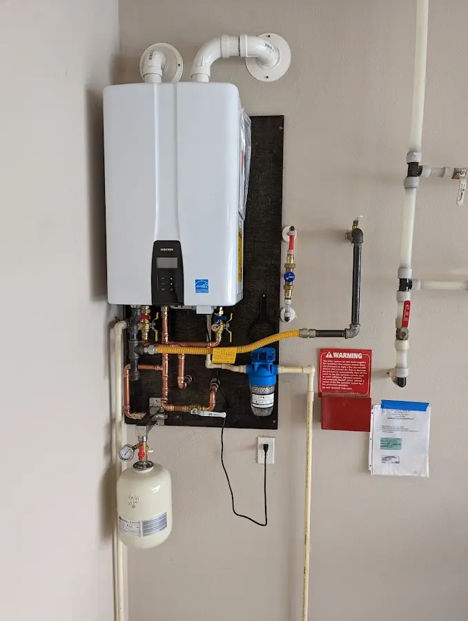 Professional plumber installing copper piping in a Montclair home